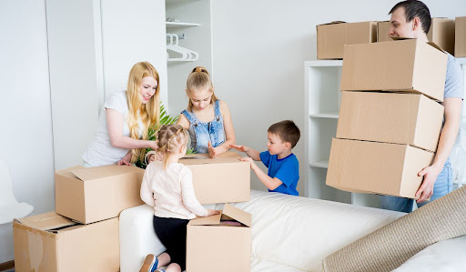 Family packing boxes together